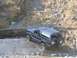 1992 Ford Bronco - A blue Ford Bronco navigates a challenging off-road terrain with steep inclines and loose sand.