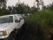 1989 Ford Bronco - Several off-road vehicles are stuck in the mud during an event.