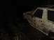 1989 Ford Bronco - A heavily mud-splattered 1987 Ford Bronco is partially submerged in dark, wet ground.