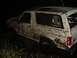 1989 Ford Bronco - A mud-covered 1989 Ford Bronco is stuck in the mud at night.