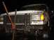 1989 Ford Bronco - A white Ford Bronco is stuck in the mud, with a jack positioned on its front grille.