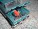 1995 Mercury Grand Marquis - Model truck with hood open reveals an orange V8 engine and interior details.