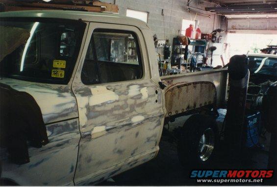 White Ford F-100 truck bodywork in progress, side view