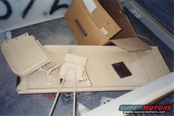 Ford F-100 tailgate with two interior door panels and a sanding block