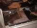 1971 Ford Torino - The interior floor of a car is visible, with damaged carpeting and exposed metal.