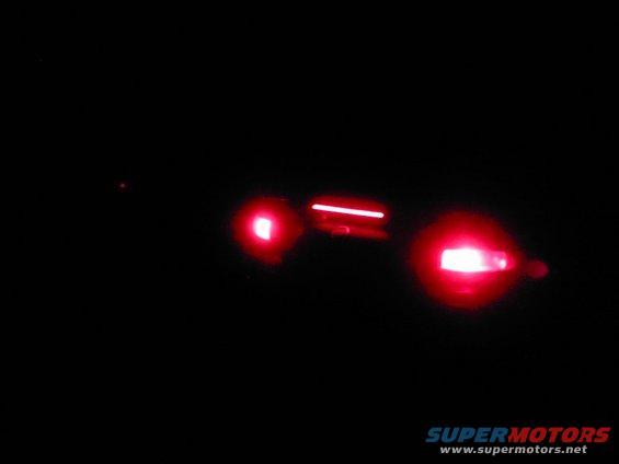 Taillight assembly with red lights illuminated against a black background