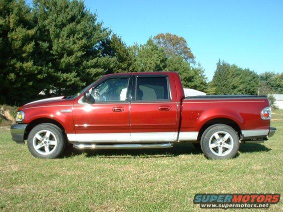2003 Ford F-150 Supercrew pickup truck, side view, red with silver lower trim