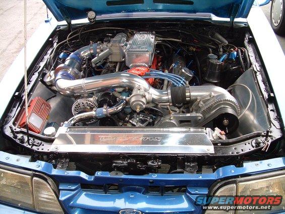 1988 Ford Mustang engine bay with supercharger and custom intake piping
