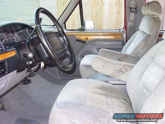 Interior view of van seats and dashboard with wood trim