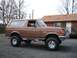 1991 Ford Bronco - Brown 1991 Ford Bronco 4x4 SUV with aftermarket wheels and brush guard.
