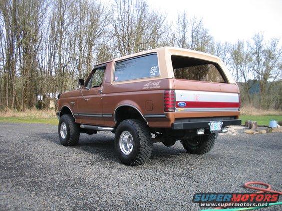 Brown Ford Bronco parked on gravel, trees in background. Has 4x4 Off Road decal on side