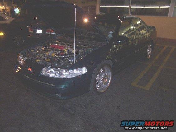 Green 1998 Mercury Sable sedan, 3/4 front view, hood open