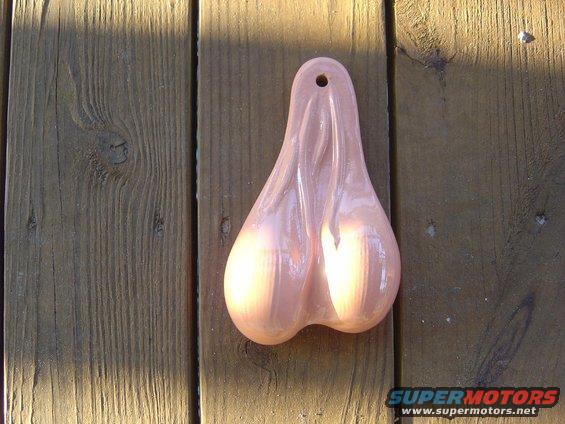 Pink truck nuts hanging on wooden planks