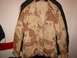 1979 Chevrolet Caprice - A desert camouflage jacket is displayed, showing its front view with several pockets and a button-up closure.