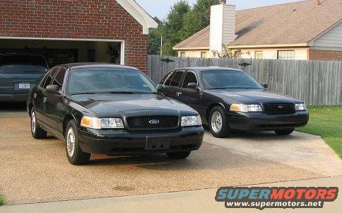 Front view of two black 1999 Ford Crown Victorias parked in a driveway