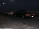 2000 Ford Crown Victoria - Two 2000 Ford Crown Victorias are seen driving on a road at night, captured from a 3/4 front view.