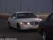 2000 Ford Crown Victoria - A white Lincoln Town Car is seen from the front, parked on the side of a road with another vehicle beside it.