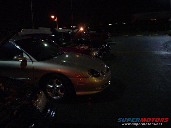 1998 Mercury Sable parked at night, front quarter view. Other cars are visible in the background