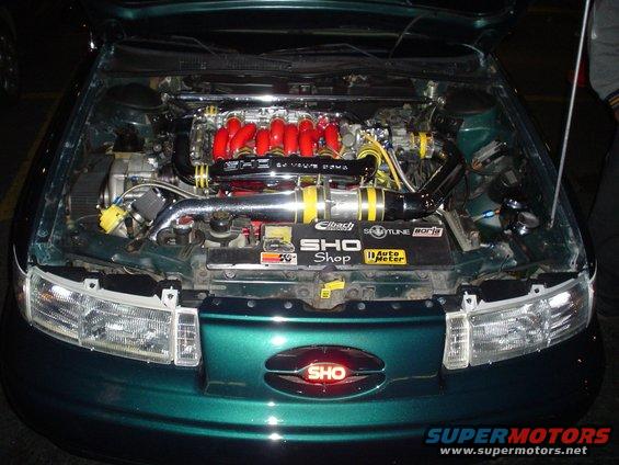 1998 Mercury Sable engine bay with custom intake and red intake runners. SHO badge on grille