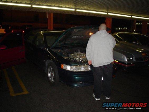 Green 1998 Mercury Sable with hood open, front 3/4 view