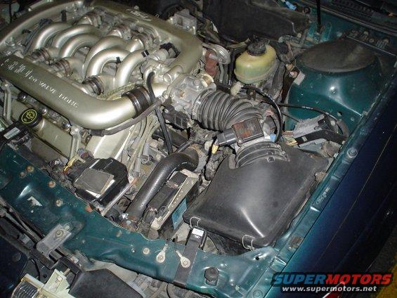 Green 1998 Mercury Sable engine bay with V8 engine, intake manifold, and air filter housing