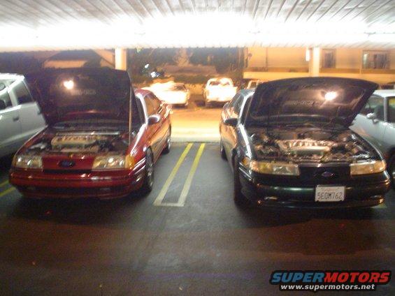 1998 Mercury Sable front view, hoods open, red and green sedans