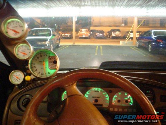 1998 Mercury Sable interior with aftermarket gauges and wood-grain steering wheel, viewed from driver's seat