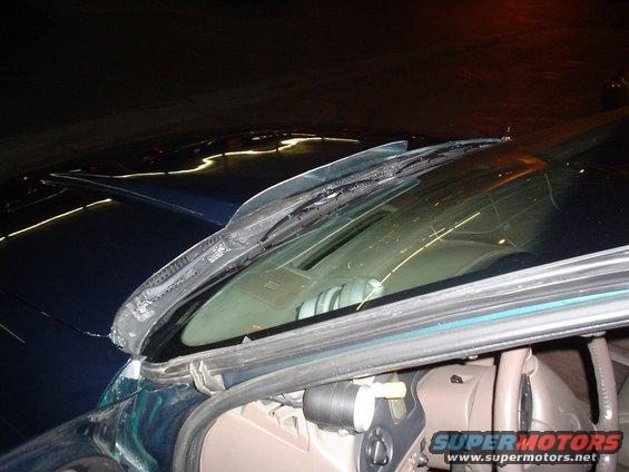 Windshield wipers on a dark car interior with SuperMotors logo visible