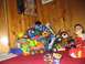 1986 Ford Bronco - A child sits amongst a large collection of toys, including several toy vehicles.