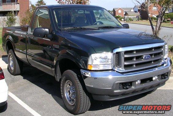 Dark green 2003 Ford F-250 regular cab pickup truck parked in a lot