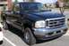 2003 Ford F-250 - Front 3/4 view of a dark green 2003 Ford F-250 pickup truck.