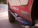 1978 Ford Bronco - The side of a vehicle shows custom rock sliders and bodywork in progress.