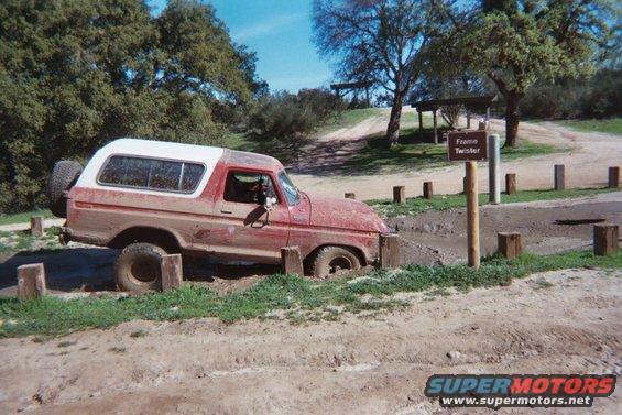 1978 Ford Bronco stuck in mud with spare tire on back