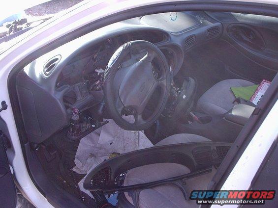 2000 Ford Taurus interior showing disassembled dashboard and steering wheel