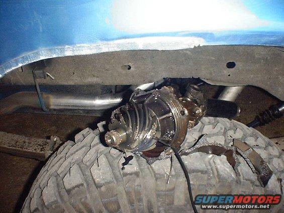 Broken differential housing on a tire, with exhaust pipe visible above