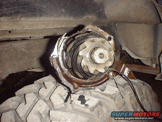 Damaged water pump impeller resting on a tire