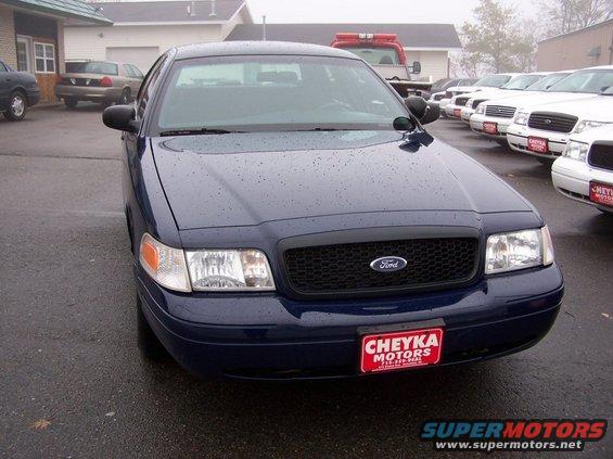 Dark blue 2001 Ford Crown Victoria front view with black grille and dealer plate