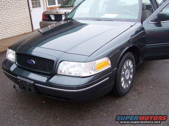 Dark green 2001 Ford Crown Victoria front 3/4 view with passenger door open