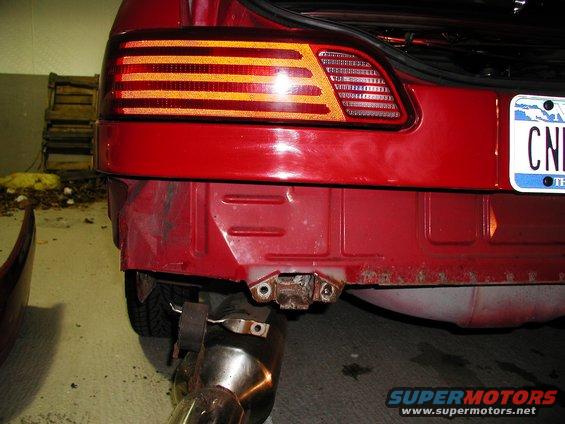 1992 Ford Taurus rear bumper area with taillight and exhaust pipe visible
