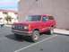 1991 Ford Bronco - Red 1991 Ford Bronco parked in a lot next to a building.