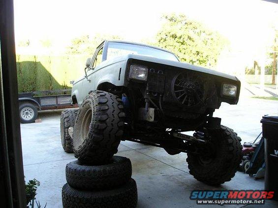 1986 Ford Bronco II with large tires on blocks, front view