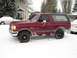 1989 Ford Bronco - Maroon 1989 Ford Bronco parked outside in a snowy environment.