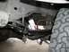 1989 Ford Bronco - Undercarriage view of a vehicle's suspension system, likely during a lift kit installation.