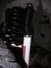 1989 Ford Bronco - A vehicle's suspension component, likely a shock and spring, is shown in detail.