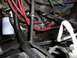 1989 Ford Bronco - Close-up view of an engine bay showing red hoses and various components.