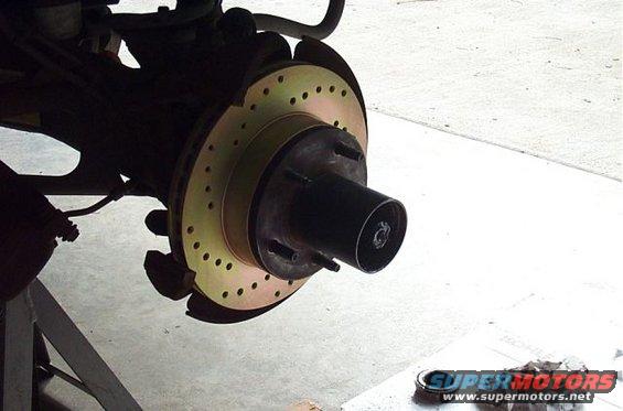 Front brake rotor with drilled holes and black hub assembly