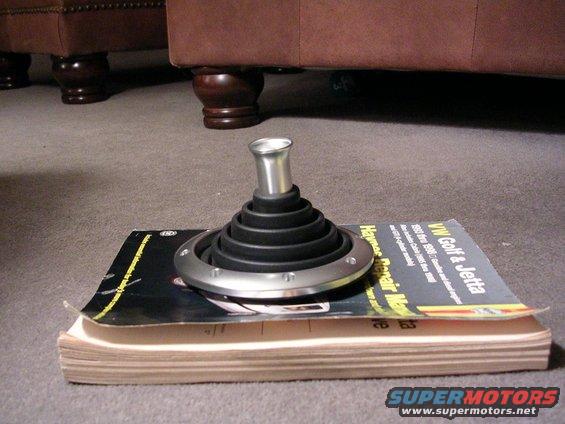 Car shifter boot and knob on top of a Haynes repair manual for VW Golf and Jetta