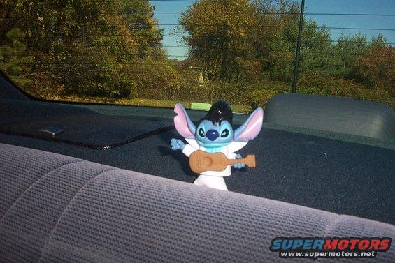 Elvis Stitch toy on car's back seat, interior view