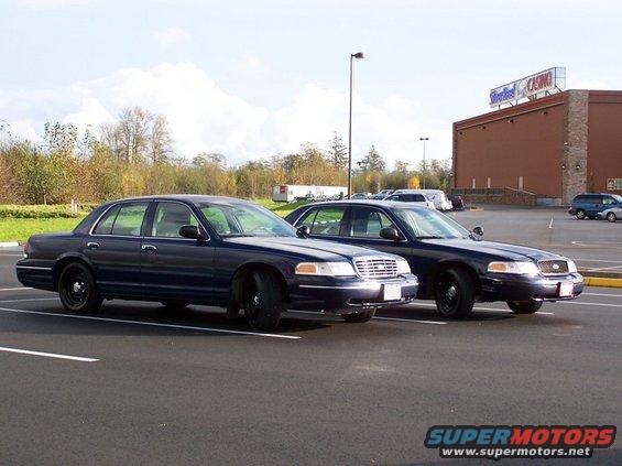 1998 Ford Crown Victoria sedans parked side-by-side in a parking lot