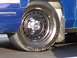 1998 Ford Crown Victoria - Close-up of a blue 1998 Ford Crown Victoria's wheel, the Ford logo on the hubcap.